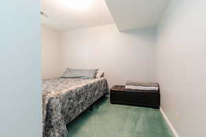 Bedroom featuring carpet flooring and baseboards