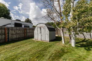 View of shed with a fenced backyard