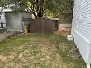 View of yard with a storage unit