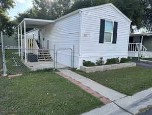 View of property exterior featuring a gate