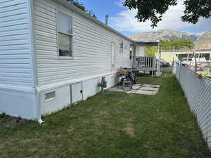 View of side of property featuring a deck with mountain view