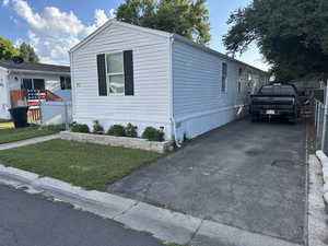 Manufactured / mobile home featuring asphalt driveway