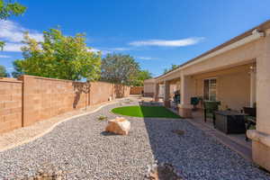 Fenced backyard with a patio