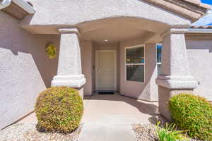 View of exterior entry with stucco siding