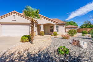 Mediterranean / spanish-style house with driveway, stucco siding, a tile roof, and a garage