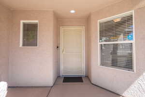 Entrance to property featuring stucco siding