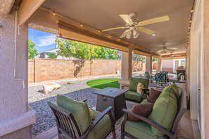 Partially Fenced backyard with a patio, a ceiling fan, an outdoor living space, and outdoor dining area