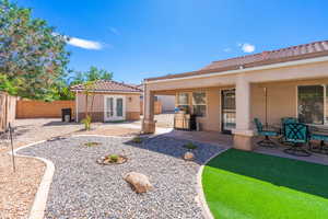 Back of house with a patio area, a fenced backyard, stucco siding, a tile roof, and casita