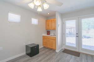 Interior space featuring french doors, a ceiling fan, and wet bar