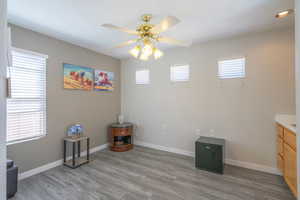 Unfurnished bedroom featuring light LVP flooring, ceiling fan, and ceiling fan