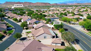Aerial perspective of suburban area with a mountainous background. CLOSE TO CLUBHOUSE