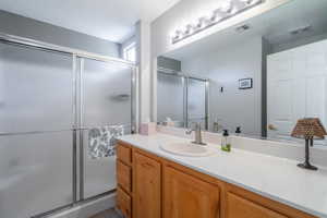 Primary Bathroom Bathroom featuring vanity and a shower stall