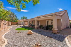 Back of property with a patio, a tile roof, stucco siding, and a fenced backyard
