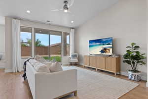 Living room with light wood-type flooring, ceiling fan, and recessed lighting