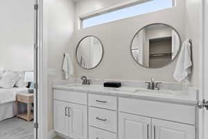 Full bathroom featuring double vanity and connected bathroom