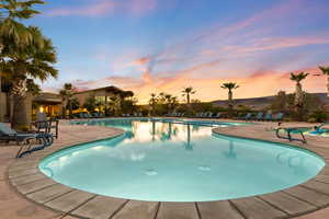 Community pool with a patio area and a mountain view