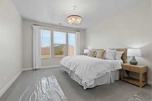 Bedroom featuring carpet flooring and a chandelier