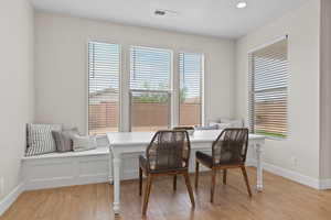 Dining area with light wood-style flooring and recessed lighting