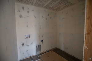 Laundry area with washer hookup and wood finished floors