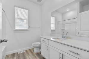 Full bath with vanity, light wood-style flooring, and bathtub / shower combination