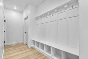 Mudroom featuring light wood-style flooring and recessed lighting