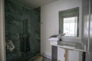 Bathroom featuring a marble finish shower