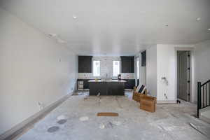 Living room featuring baseboards and a textured ceiling