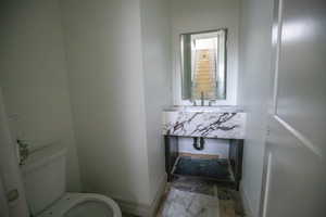 Half bathroom with vanity and toilet