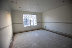 Empty room featuring baseboards