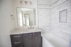Full bathroom with vanity and bathing tub / shower combination