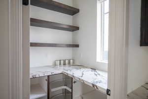 Home office featuring built in study area and healthy amount of natural light