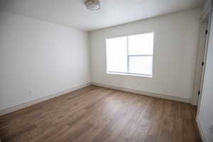 Unfurnished room with light wood-style flooring and a textured ceiling