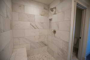 Bathroom featuring a tile shower
