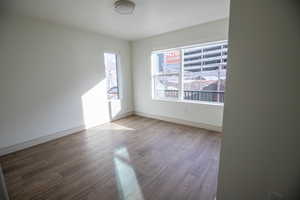 Unfurnished room featuring wood finished floors and a textured ceiling