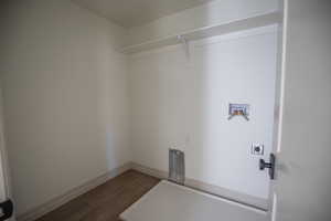 Washroom featuring hookup for a washing machine, dark wood-style floors, and electric dryer hookup