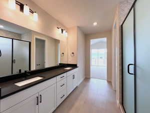 Owner's bathroom with a large walk-in shower and double vanity