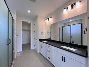 Owner's bathroom with a large walk-in shower, double vanity and a spacious closet,