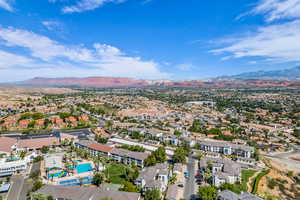 Aerial perspective of suburban area with a mountainous background and a pool