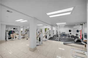 Gym featuring light tile patterned floors