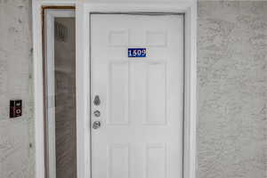 Property entrance featuring stucco siding