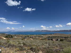 View of mountain backdrop featuring a nearby body of water