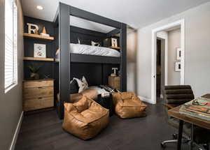 Bedroom with baseboards and dark wood finished floors
