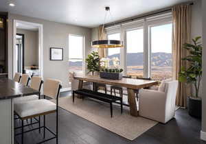 Dining room with dark wood-style floors, a mountain view, and recessed lighting