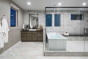 Full bath featuring vanity, tile walls, a stall shower, light marble finish flooring, and a freestanding bath