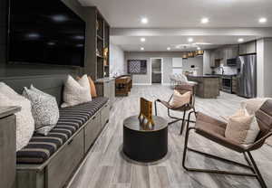 Living area featuring wood finish floors and recessed lighting