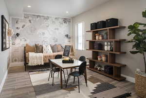 Sitting room with an office area, wood tiled floors, an accent wall, and recessed lighting
