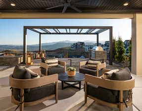 View of patio / terrace with a mountain view, a ceiling fan, exterior kitchen, an outdoor hangout area, and a pergola