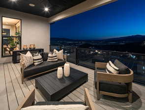 Wooden terrace with an outdoor living space and a patio area