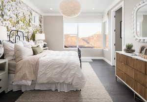 Bedroom with dark wood-style floors, crown molding, a mountain view, and recessed lighting