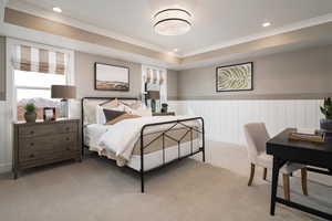 Bedroom with multiple windows, carpet, recessed lighting, a raised ceiling, and a wainscoted wall